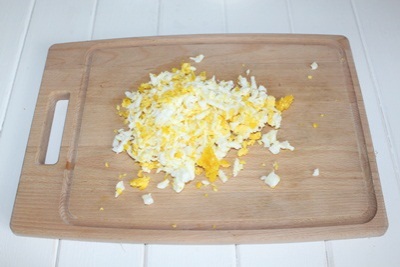 Salad with corn and mushrooms Boil the eggs, peel them on a medium grater.