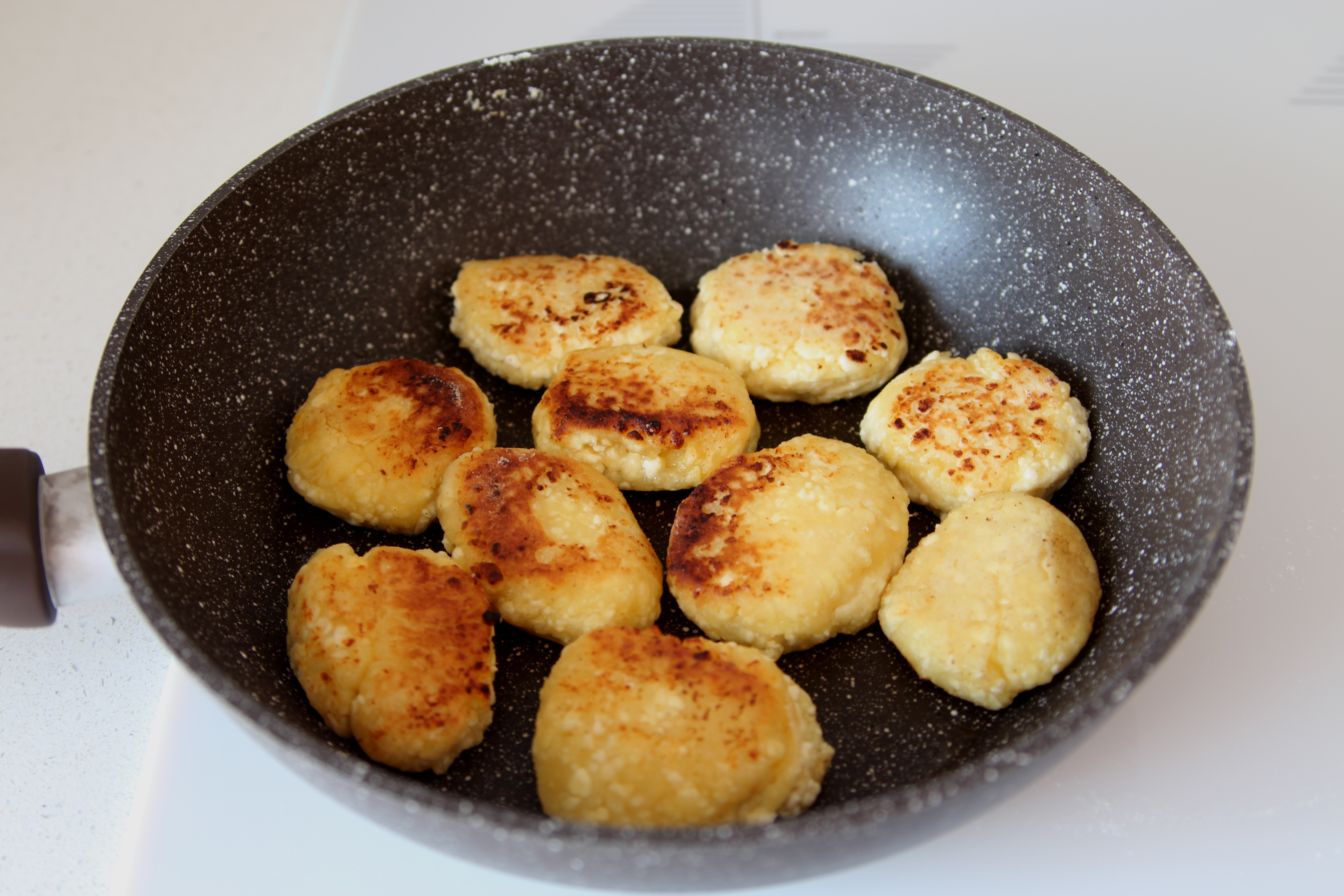 Recette Syrniki - Crêpes au fromage russe Mettez la pâte dans une poêle chaude et faites-la frire jusqu'à ce qu'elle soit rosée.  Des deux côtés.